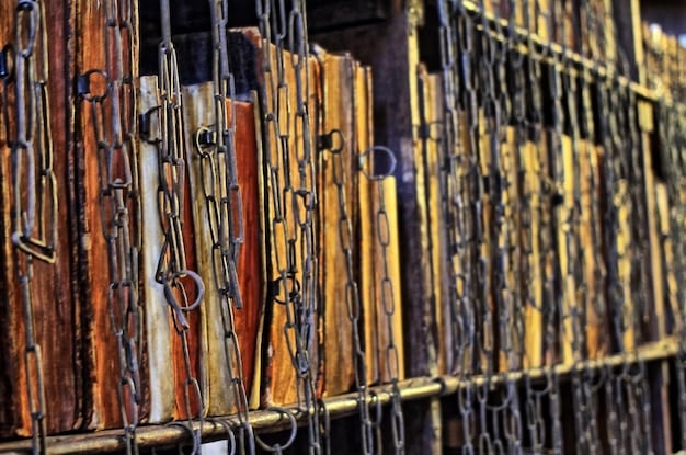 A row of law books with a digital padlock on one of them, representing the challenge of applying traditional law to digital smart contracts.