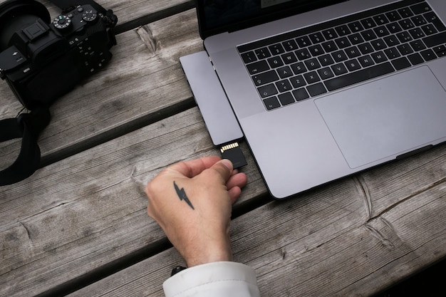 A close-up of a hardware wallet device connected to a laptop, showing a transaction being signed securely.